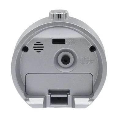 Back view of SEIKO QHE207SLH alarm clock showing rear alarm controls, on/off switch, speaker opening, time and alarm adjustment, and battery cover.