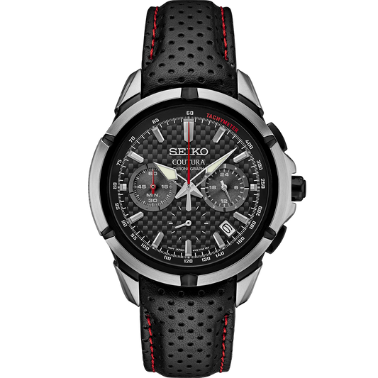 A SEIKO COUTURA SSB437 watch with a black perforated leather strap, black dial with carbon-fiber pattern, and silver subdials. The watch has a stainless steel case and a sapphire crystal cover.