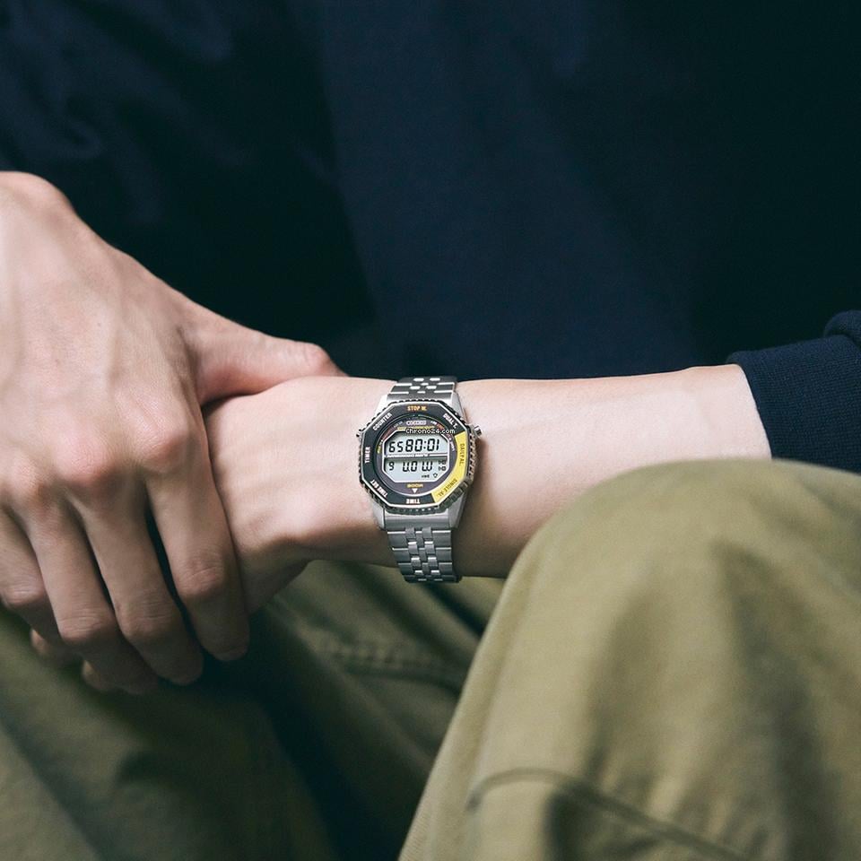 Person wearing a digital watch with a dark background