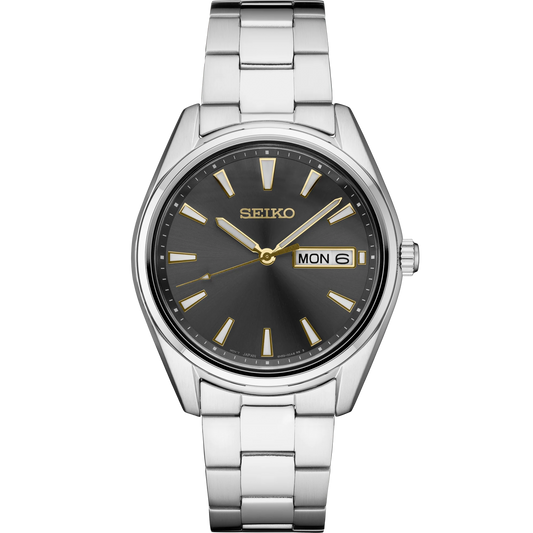 Seiko SUR343 Essentials quartz watch with dark gray sunray dial, gold accents, 40.2mm stainless steel case and bracelet, sapphire crystal, LumiBrite hands and markers, day-date display, and 100m water resistance.
