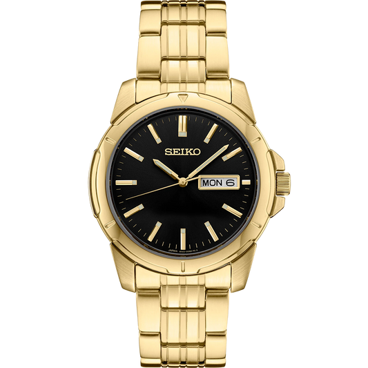 Seiko Essentials SUR358 quartz watch with black sunray dial, gold-tone stainless steel case and bracelet, day-date display, LumiBrite hands and markers, and 100m water resistance.