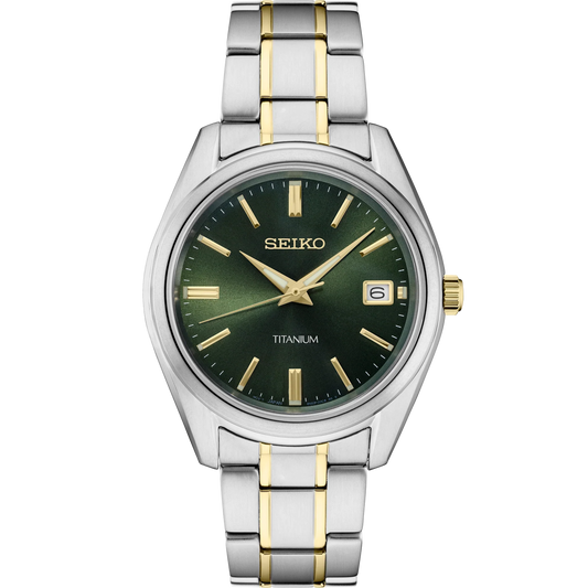Seiko Essentials SUR377 quartz watch with green sunray dial, gold accents, two-tone titanium case and bracelet, sapphire crystal, date display, and 100m water resistance.