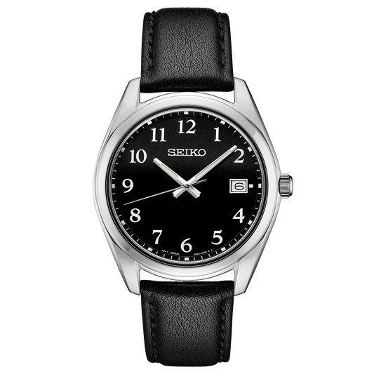 Seiko watch with black leather strap and black dial on a white background