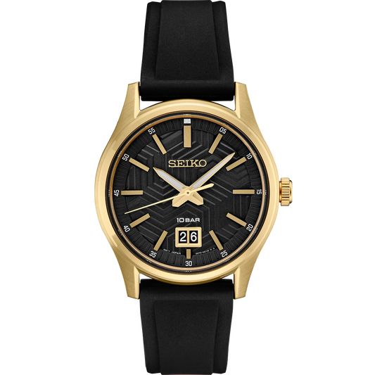 SEIKO SUR560 from the Essentials Collection – matte black dial with y-pattern, gold accents, big date display, gold-tone stainless steel case, black silicone strap, and 100m water resistance.