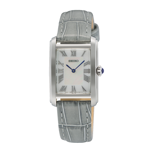 Seiko SWR099 Essentials – stainless steel rectangular quartz watch with white Roman numeral dial, blue hands, grey leather strap, Hardlex crystal, and 50m water resistance.