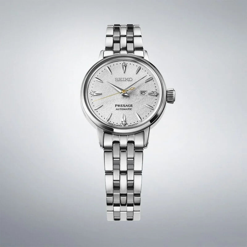 Silver Seiko watch on a gray background