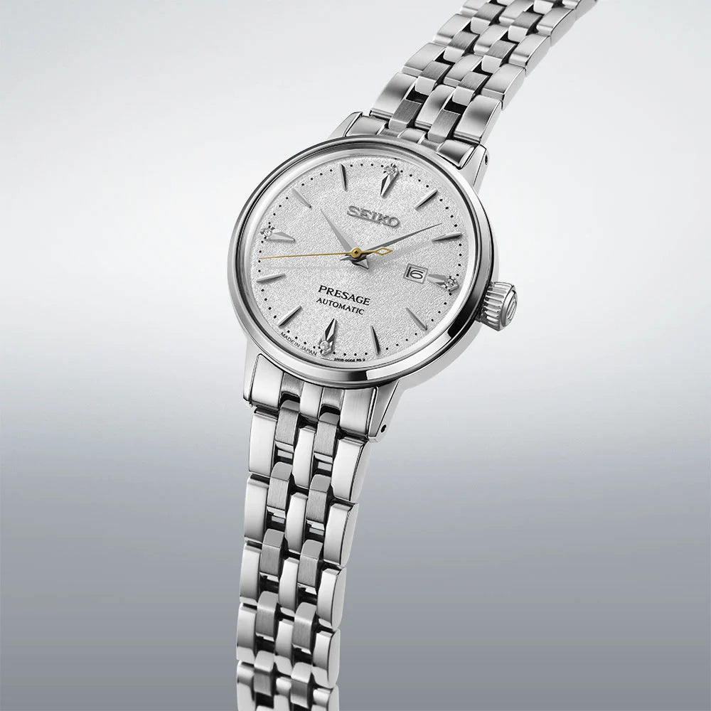 Silver Seiko watch on a light gray background