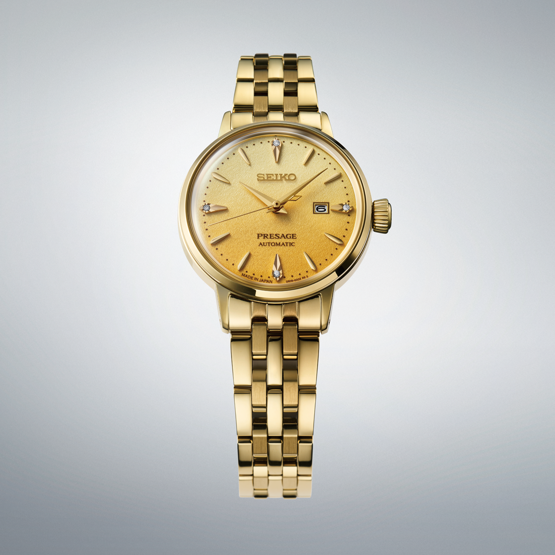 Gold Seiko watch on a gray background