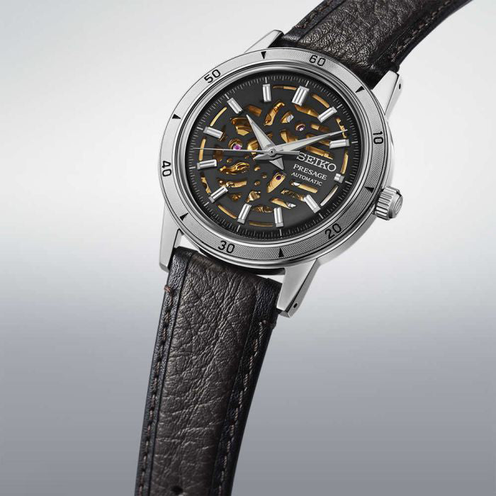 Seiko Presage watch with black leather strap on a light gray background