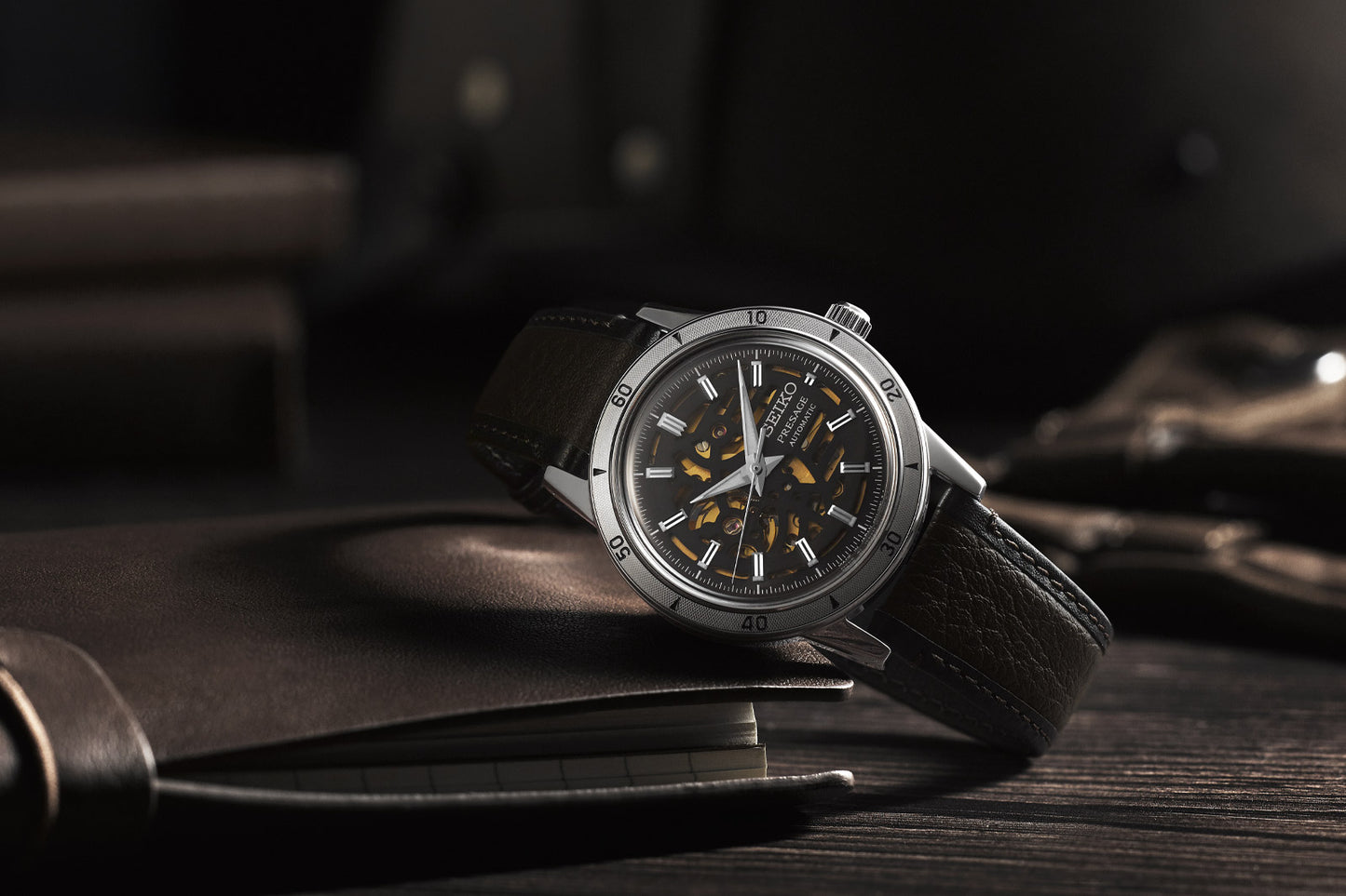 Luxury watch with a black strap on a dark surface