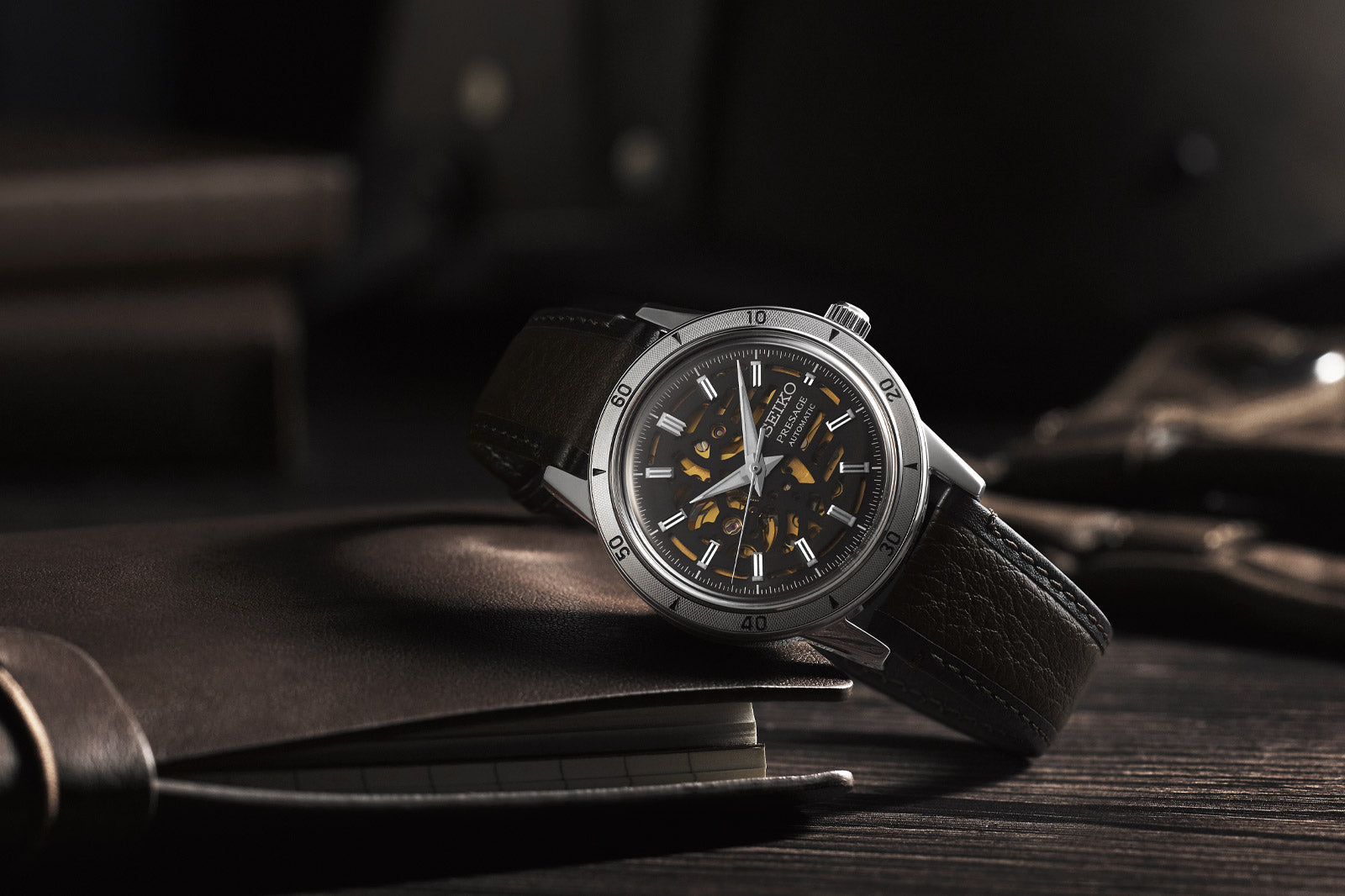 Luxury watch with a black strap on a dark surface