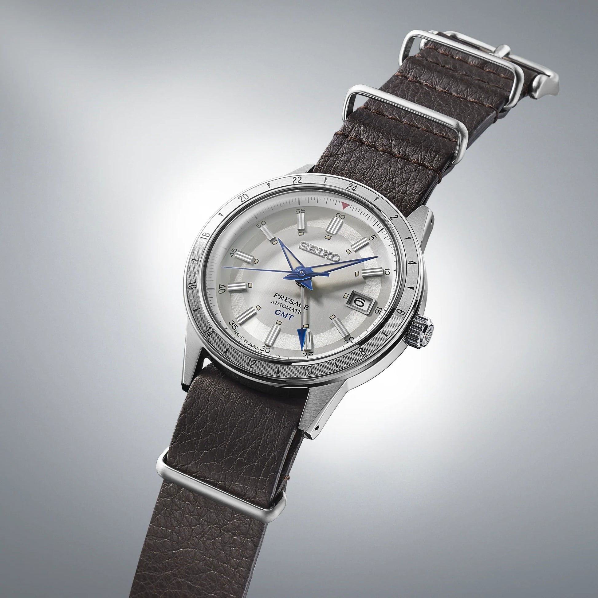 SEIKO Presage 110th Anniversary Limited Edition – white dial with silver GMT bezel, retro 1960s car-inspired design, automatic GMT movement, sustainable brown leather strap, and 100m water resistance.