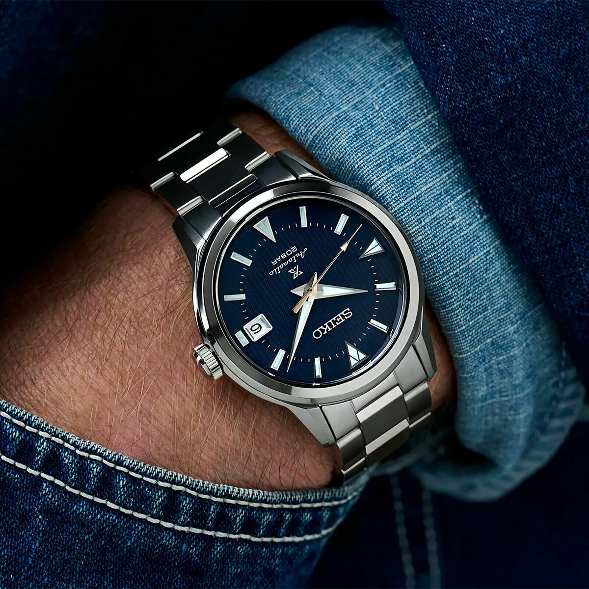 SEIKO Prospex SPB249 Alpinist – blue patterned dial with mountain-shaped markers, stainless steel case and bracelet, curved sapphire crystal, automatic movement, and 200m water resistance.