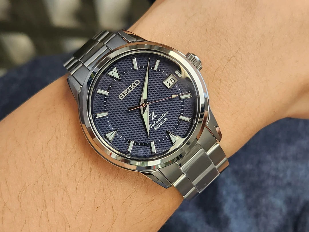 SEIKO Prospex SPB249 Alpinist – blue patterned dial with mountain-shaped markers, stainless steel case and bracelet, curved sapphire crystal, automatic movement, and 200m water resistance.