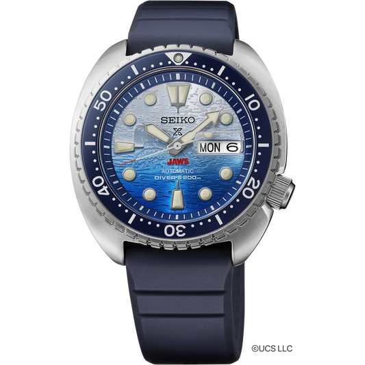 Seiko Prospex SRPL81 JAWS 50th Anniversary Limited Edition diver’s watch with 45 mm stainless steel case, blue ceramic unidirectional bezel, blue and white ombre dial with JAWS logo at 6 o’clock, LumiBrite hands and markers, sapphire crystal, Caliber 4R36 automatic movement, 200m ISO-certified water resistance, blue silicone strap, and engraved caseback featuring Orca boat and shark fin. Limited edition of 5,000 pieces.