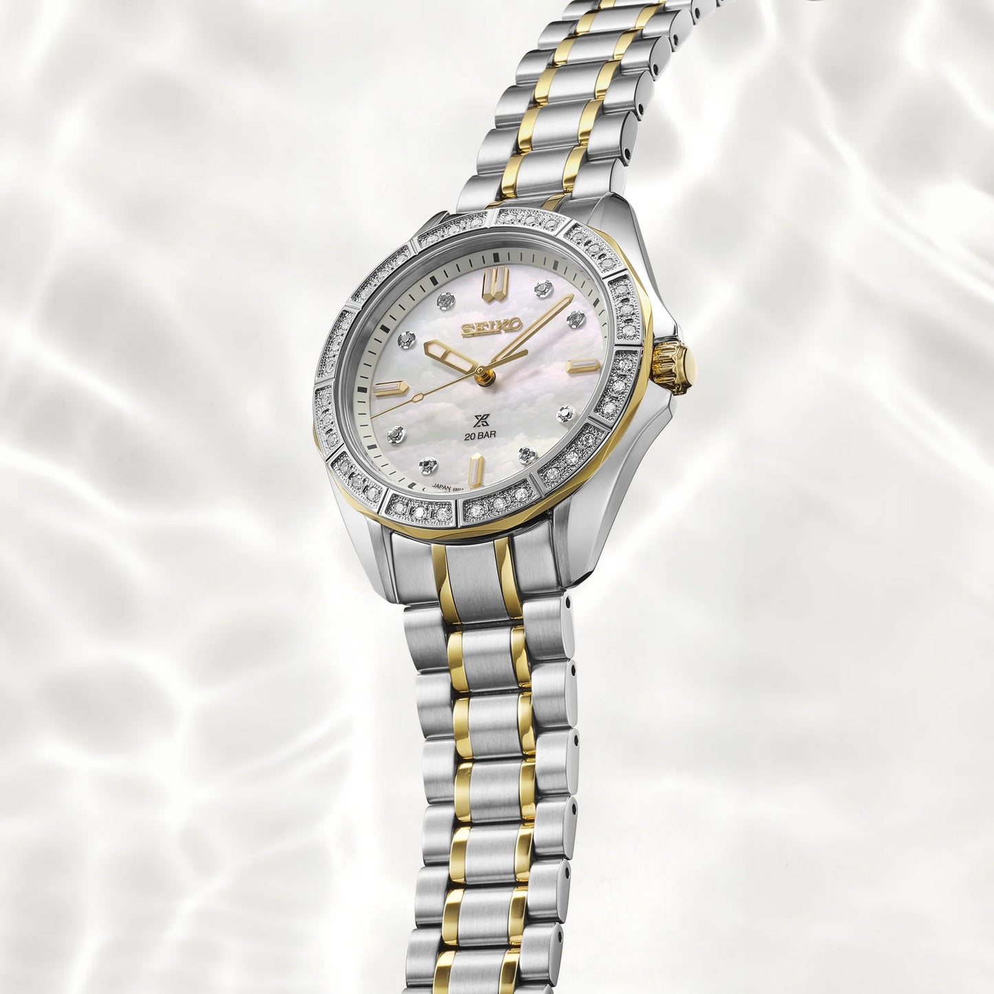 Silver and gold watch with Seiko logo on a white background