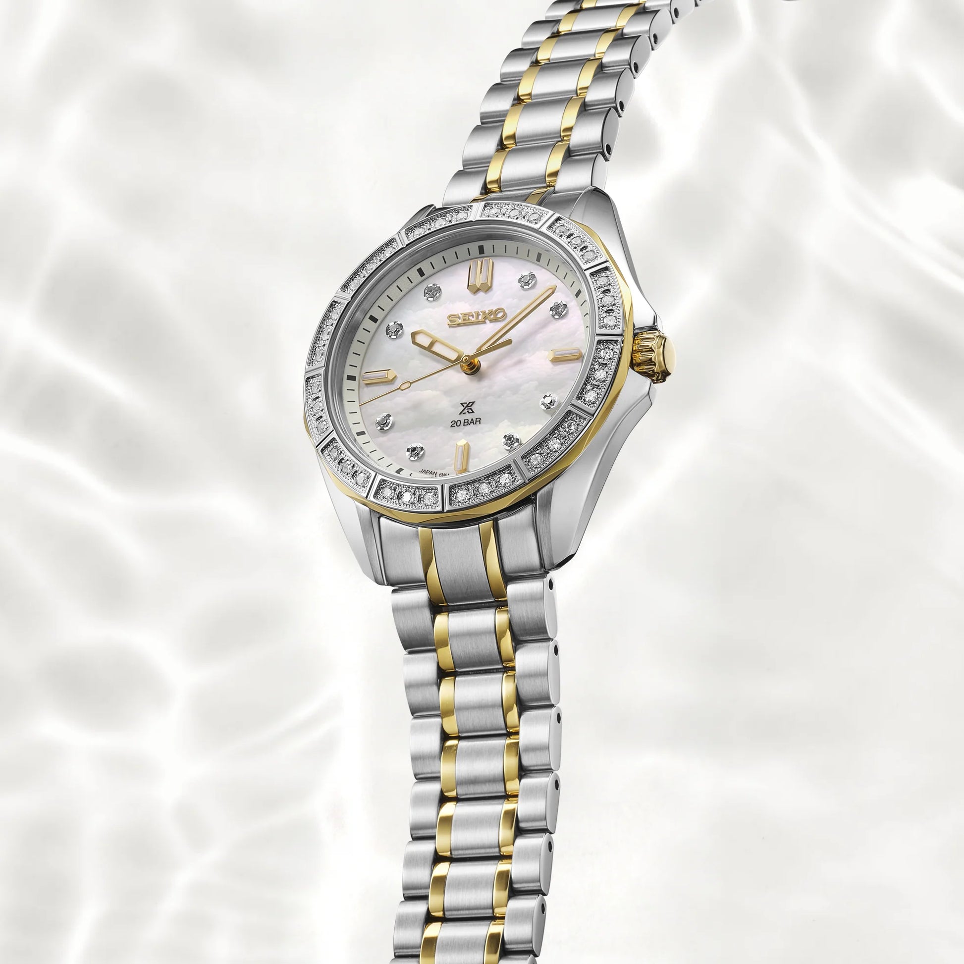 Silver and gold watch with Seiko logo on a white background