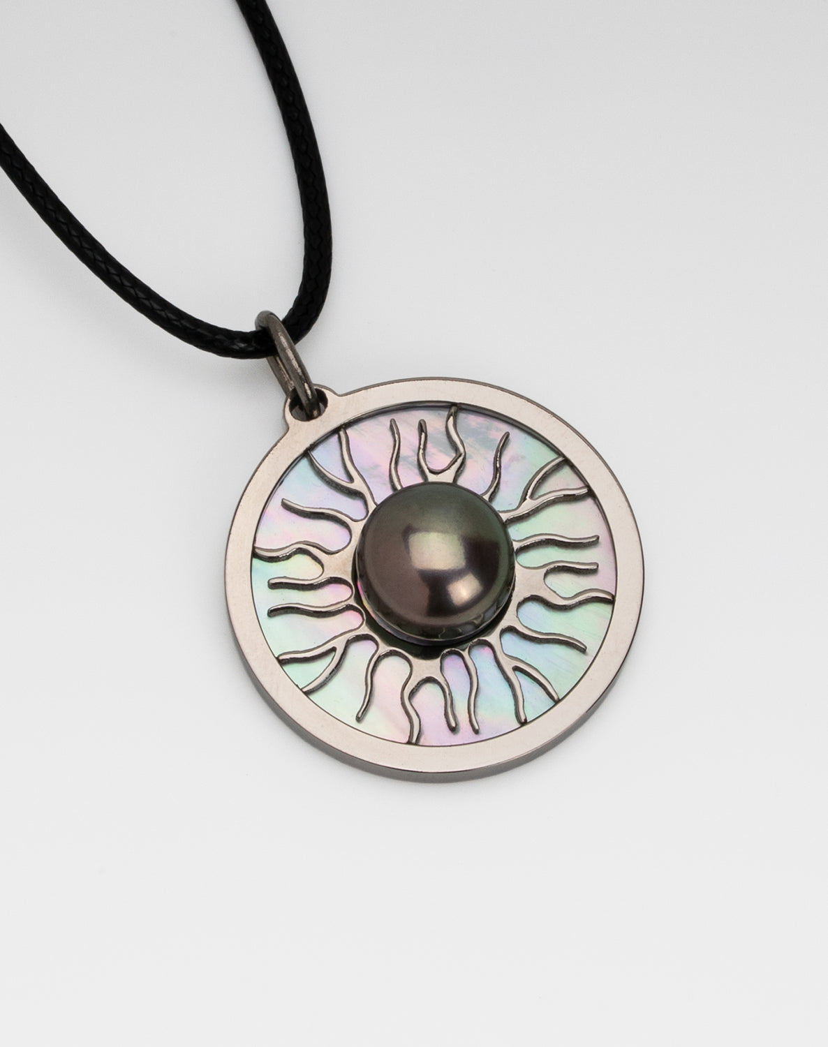 Titanium black freshwater pearl necklace with mother-of-pearl inlay, 10-11mm dyed black button-shaped pearl, exclusive sun-inspired design by Miseki Jewelry, adjustable waxed cotton cord, stainless steel lobster clasp