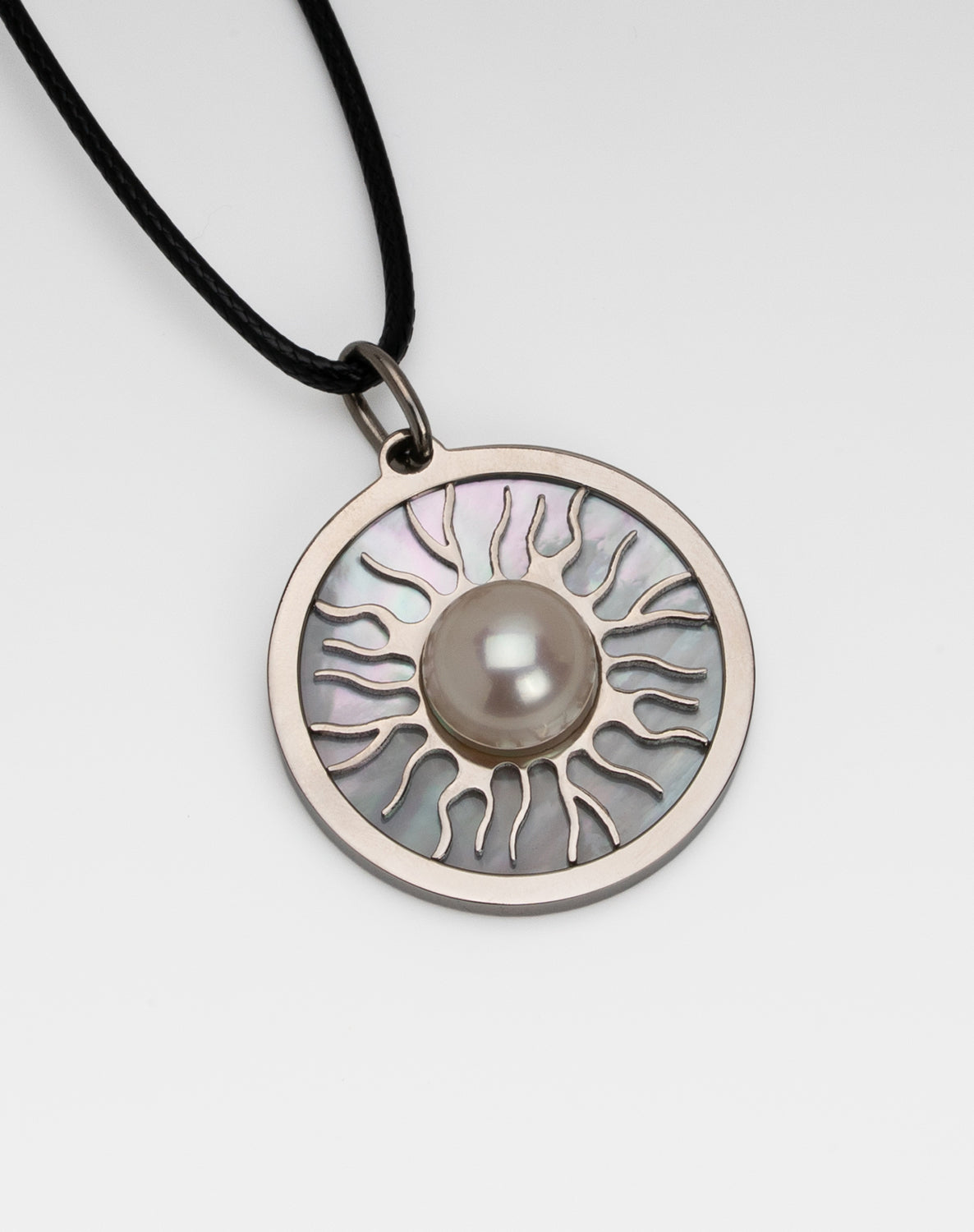 Titanium natural pink freshwater pearl necklace with mother-of-pearl inlay, 9.5mm button-shaped pearl, sun-inspired exclusive design by Miseki Jewelry, adjustable waxed cotton cord, stainless steel lobster clasp