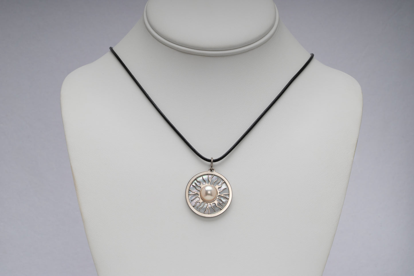 Titanium natural pink freshwater pearl necklace with mother-of-pearl inlay, 9.5mm button-shaped pearl, sun-inspired exclusive design by Miseki Jewelry, adjustable waxed cotton cord, stainless steel lobster clasp