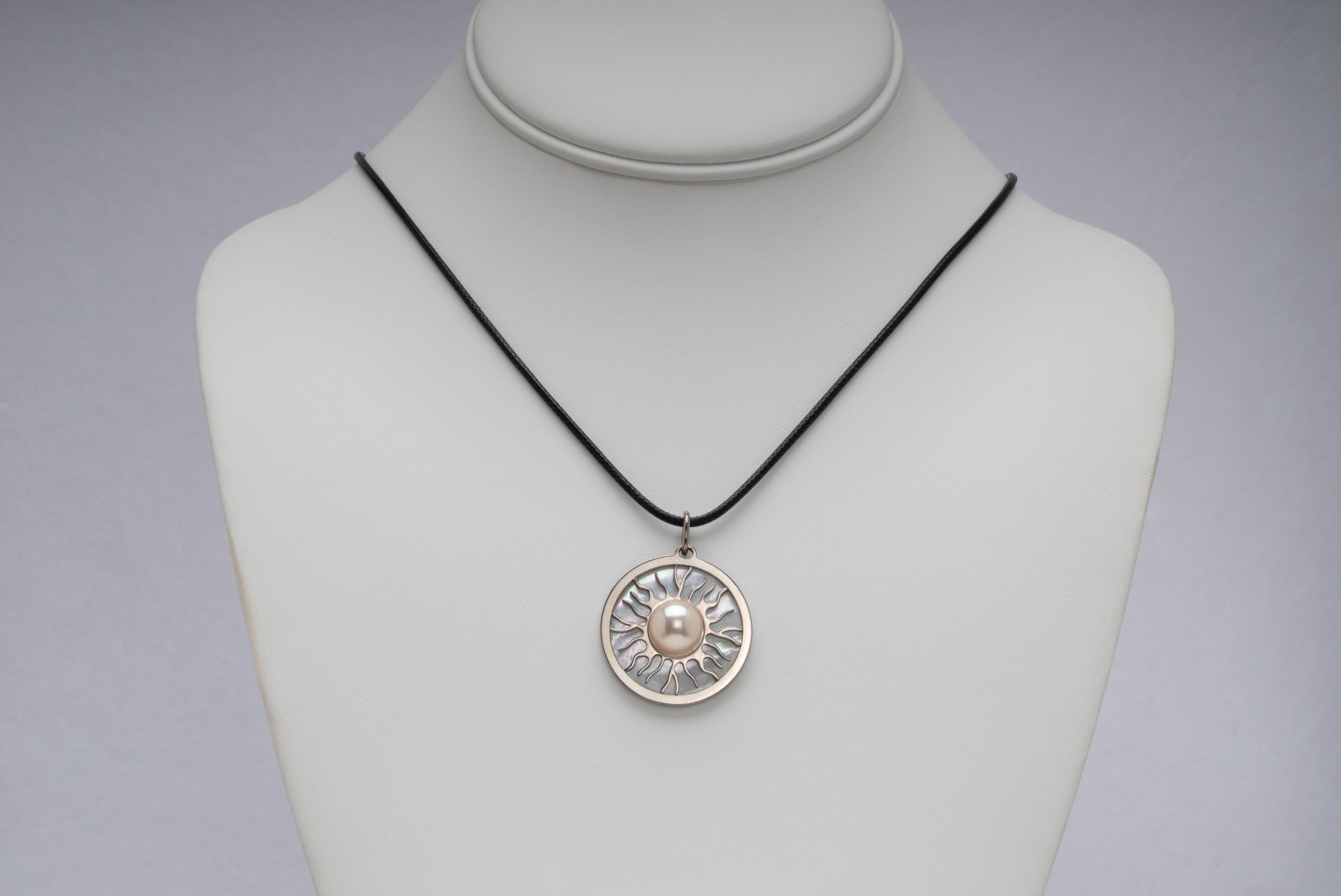 Titanium natural pink freshwater pearl necklace with mother-of-pearl inlay, 9.5mm button-shaped pearl, sun-inspired exclusive design by Miseki Jewelry, adjustable waxed cotton cord, stainless steel lobster clasp