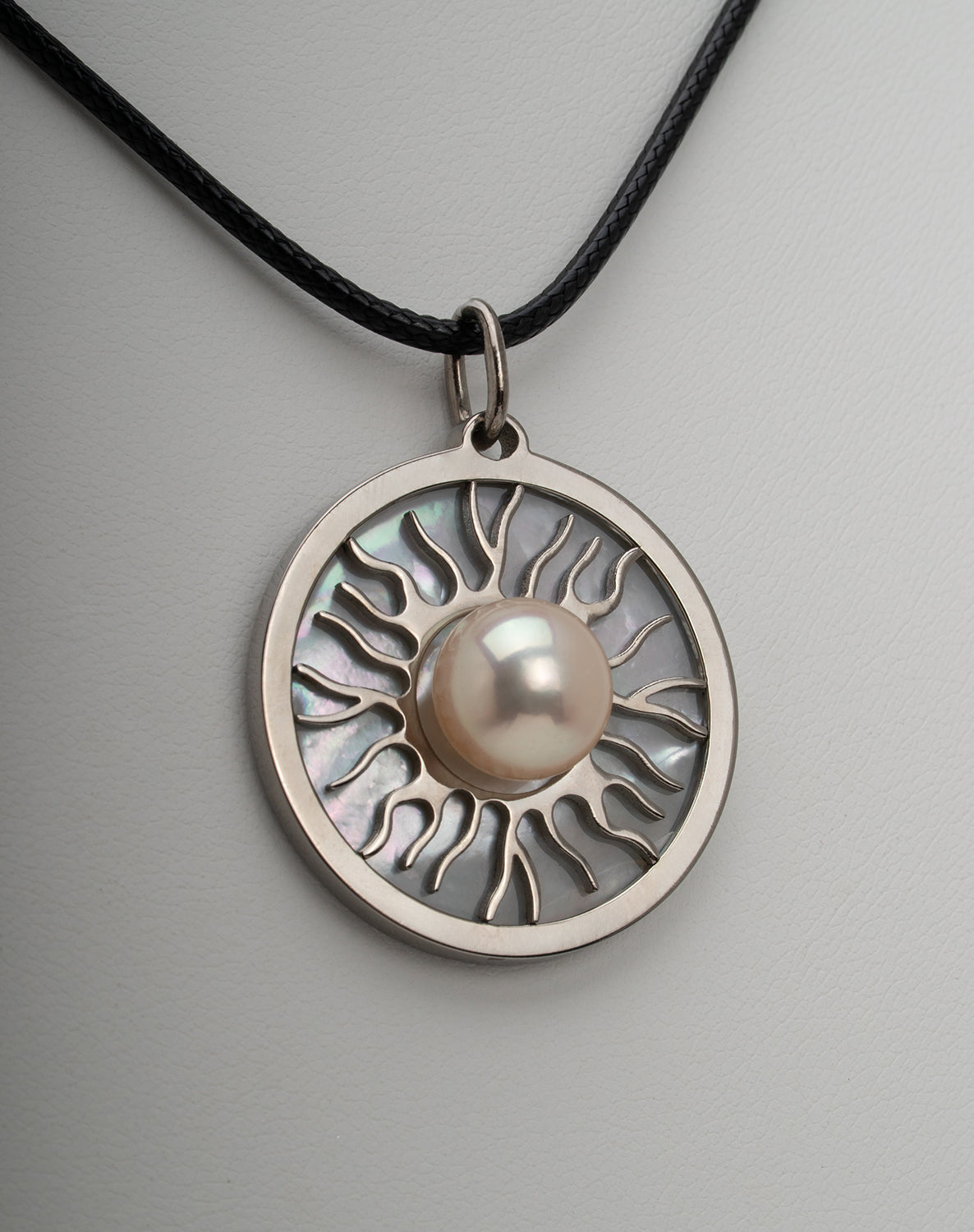 Titanium natural pink freshwater pearl necklace with mother-of-pearl inlay, 9.5mm button-shaped pearl, sun-inspired exclusive design by Miseki Jewelry, adjustable waxed cotton cord, stainless steel lobster clasp