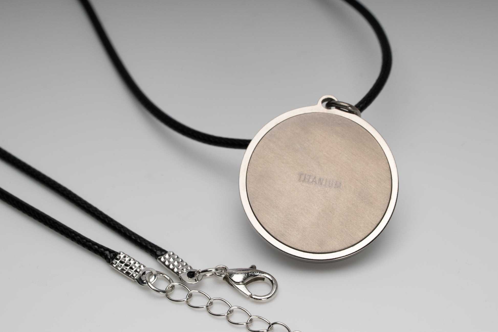 Titanium natural pink freshwater pearl necklace with mother-of-pearl inlay, 9.5mm button-shaped pearl, sun-inspired exclusive design by Miseki Jewelry, adjustable waxed cotton cord, stainless steel lobster clasp