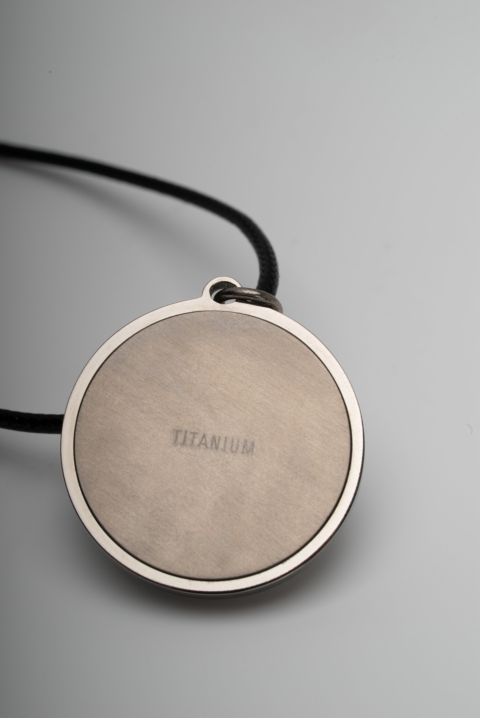 Titanium natural pink freshwater pearl necklace with mother-of-pearl inlay, 9.5mm button-shaped pearl, sun-inspired exclusive design by Miseki Jewelry, adjustable waxed cotton cord, stainless steel lobster clasp