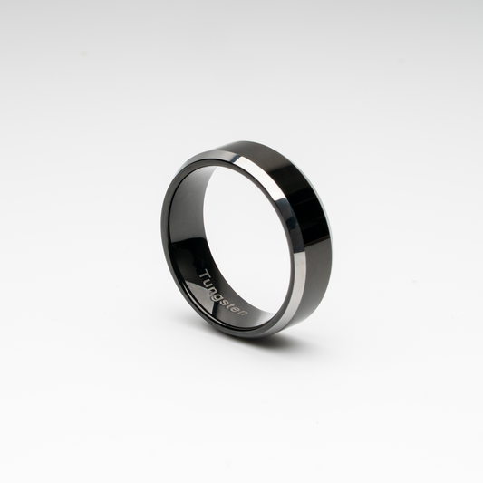 Polished black tungsten carbide ring with bold beveled edges. Minimalist, scratch-resistant, and comfort fit—perfect as a men’s wedding band, promise ring, or modern unisex fashion accessory.