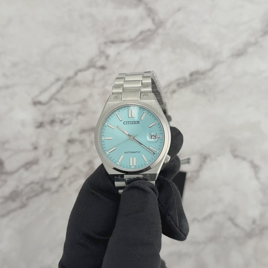 Citizen TSUYOSA NJ0200-50L – 37mm silver-tone stainless steel case, sunray ice blue dial, automatic movement, sapphire crystal, stainless steel bracelet, and 50m water resistance.