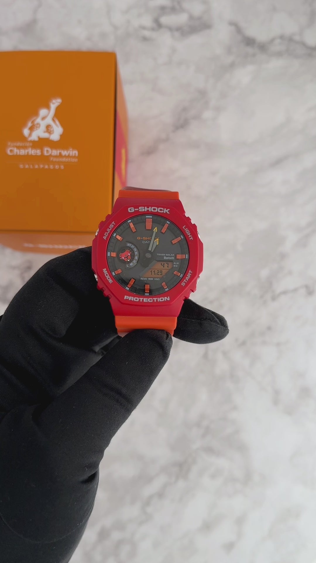 Casio G-SHOCK GA-B2100DF-4A Charles Darwin Foundation collaboration model – inspired by the Sally Lightfoot Crab with vivid red/orange colors, bio-based resin, Tough Solar, Bluetooth Smartphone Link, and Galápagos-themed design details.