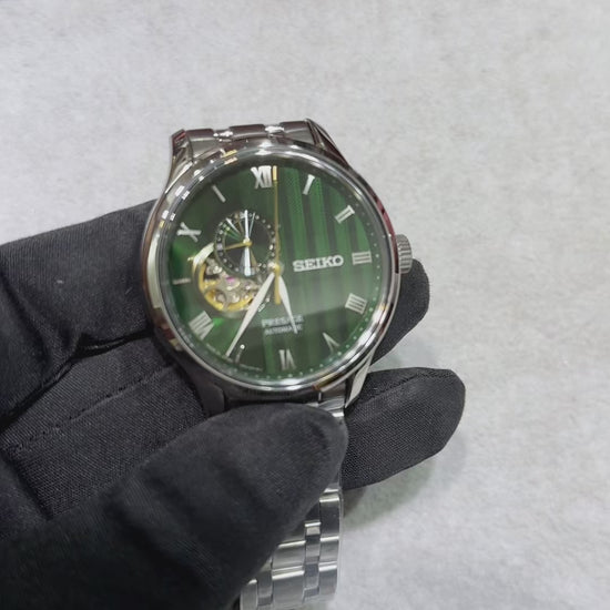 Seiko Presage SSA463 Japanese Garden automatic watch with deep green textured dial, open-heart display, Roman numeral markers, stainless steel case and bracelet, and dual-curved sapphire crystal.