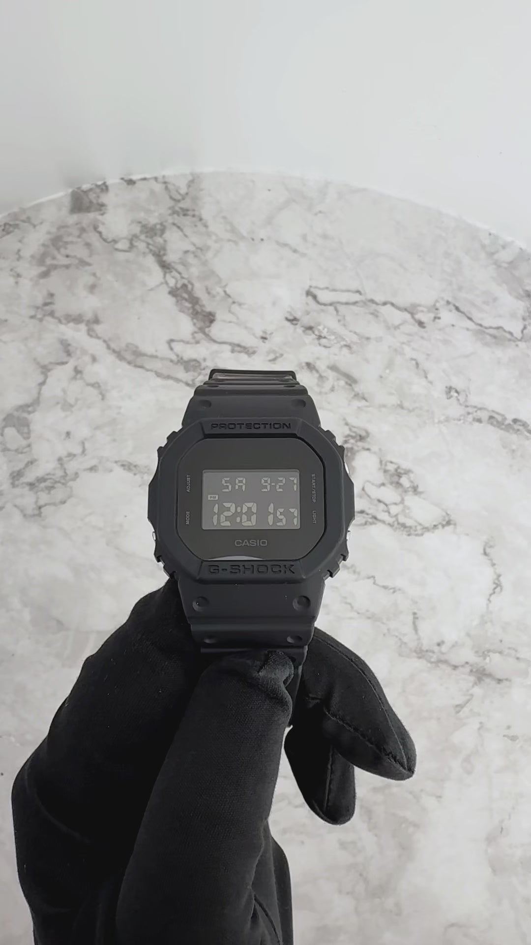 Casio G-Shock DW5600BB-1 matte black digital watch with square face, 200-meter water resistance, and electro-luminescent backlight in blackout design