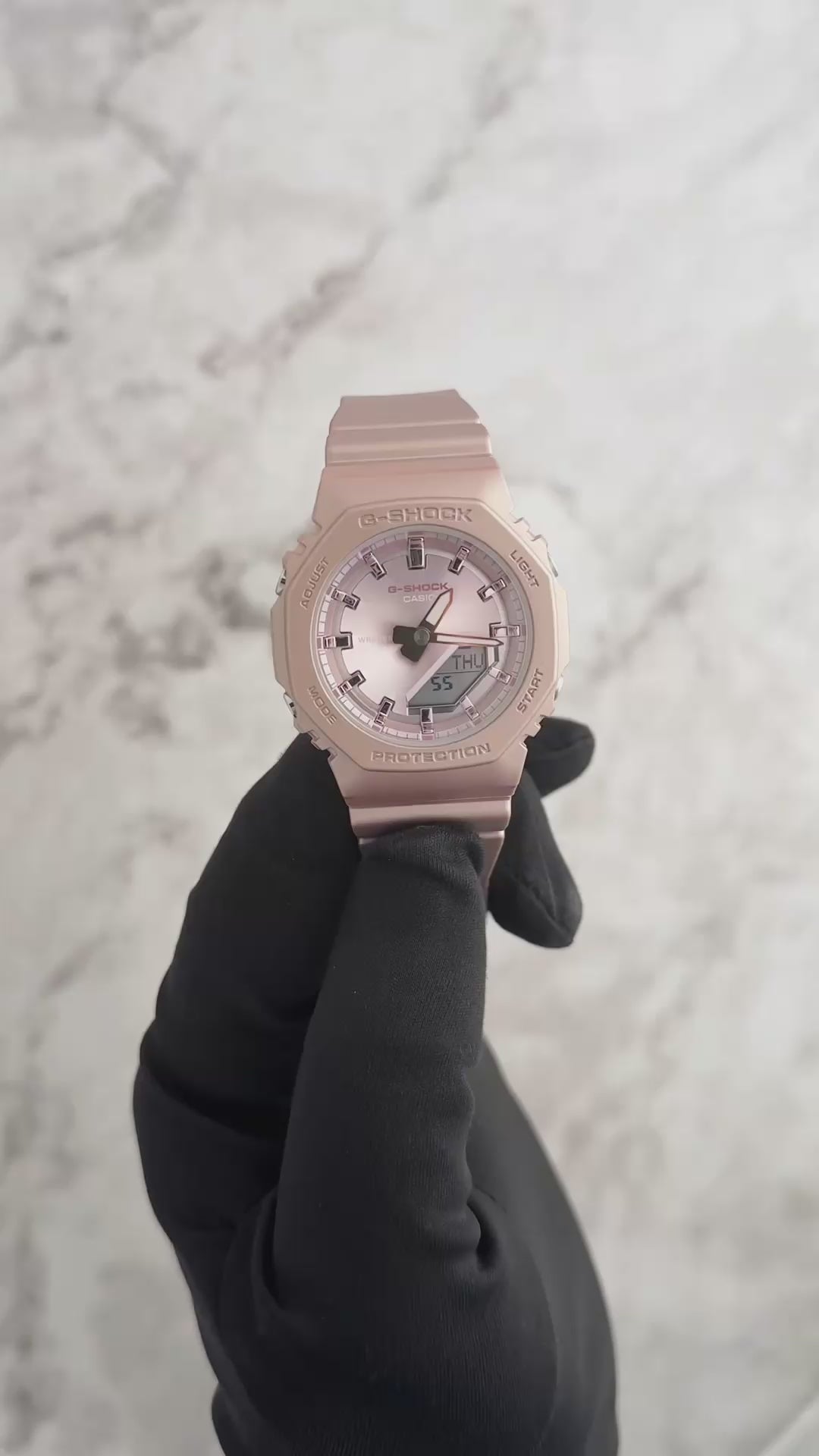 Casio G-SHOCK GMAP2100ST-4A – slim metallic-pink bio-based resin watch with pearlescent polarized finish, octagonal bezel, analog-digital display, and 200m water resistance.