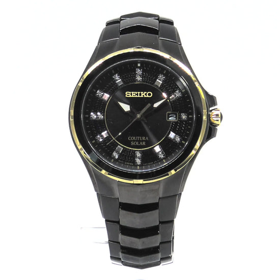 Seiko Coutura SNE506 men’s solar watch with black ion-plated stainless steel case, gold accents, black sunray dial with 15 diamond markers, and black stainless steel bracelet.