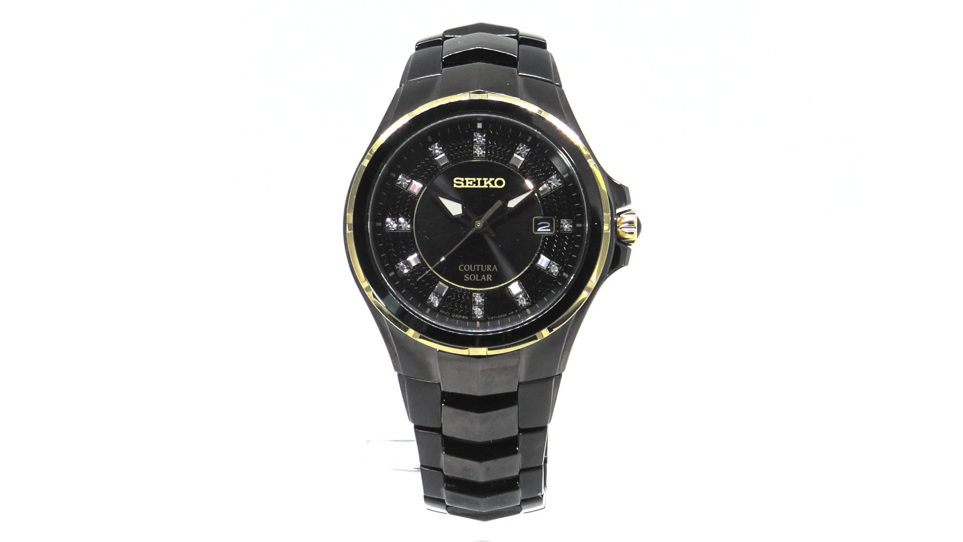 Seiko Coutura SNE506 men’s solar watch with black ion-plated stainless steel case, gold accents, black sunray dial with 15 diamond markers, and black stainless steel bracelet.