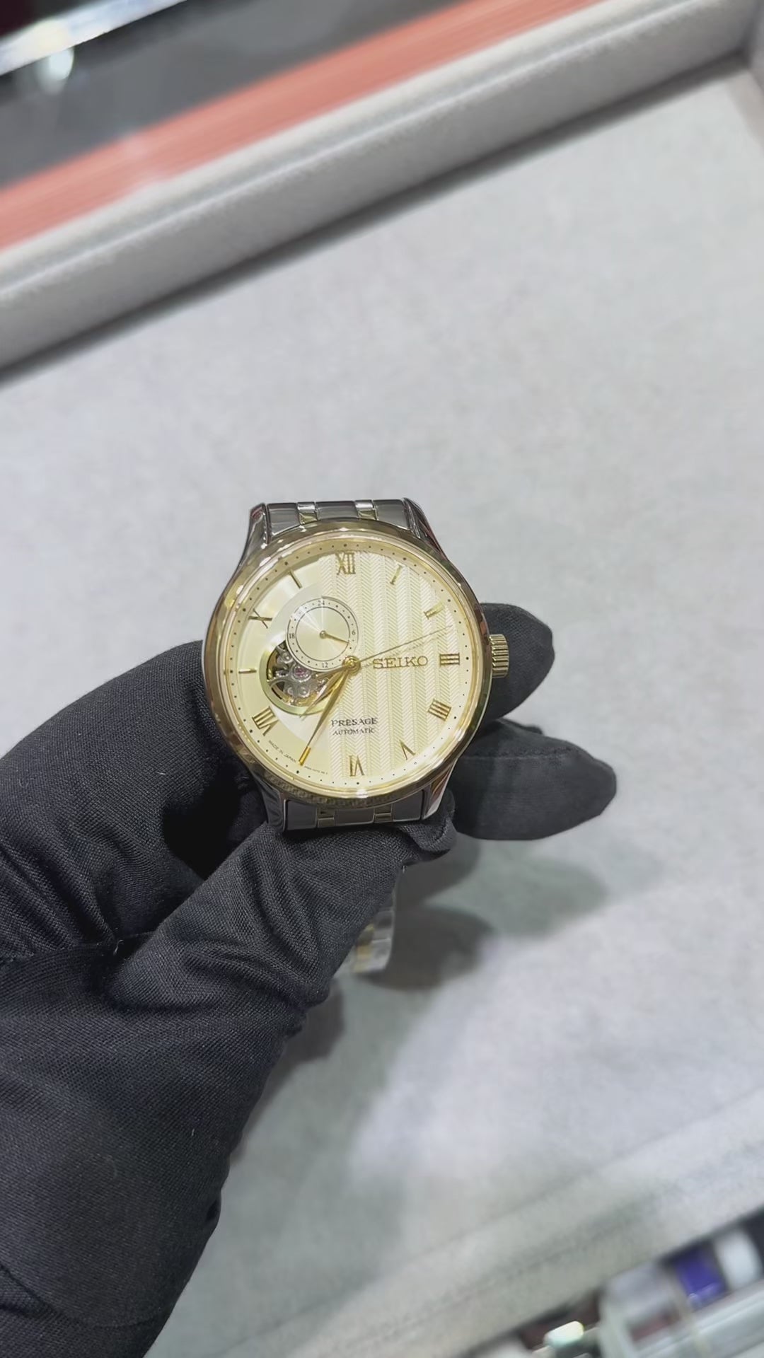 Seiko Presage SSA464 Japanese Garden automatic watch with ivory-gold textured dial, Roman numeral markers, open-heart display, gold-tone bezel, and two-tone stainless steel bracelet.