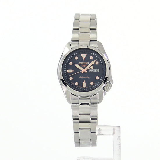 Seiko 5 Sports SRE003 automatic watch with navy blue sunray dial, luminous hands and markers, stainless steel case and bracelet, and compact vintage-inspired design.
