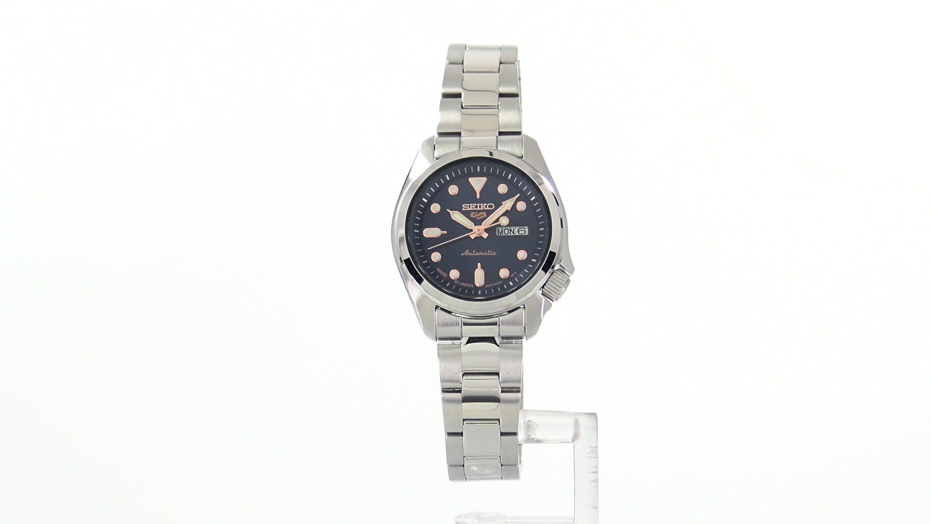 Seiko 5 Sports SRE003 automatic watch with navy blue sunray dial, luminous hands and markers, stainless steel case and bracelet, and compact vintage-inspired design.
