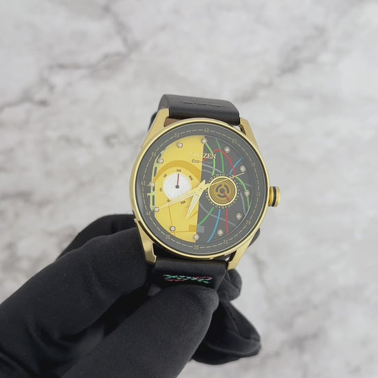 CITIZEN Star Wars C-3PO Rewired BU4026-05W – gold-tone Eco-Drive watch with yellow dial, C-3PO-inspired details, black leather strap with colorful stitching, and WR100 water resistance.