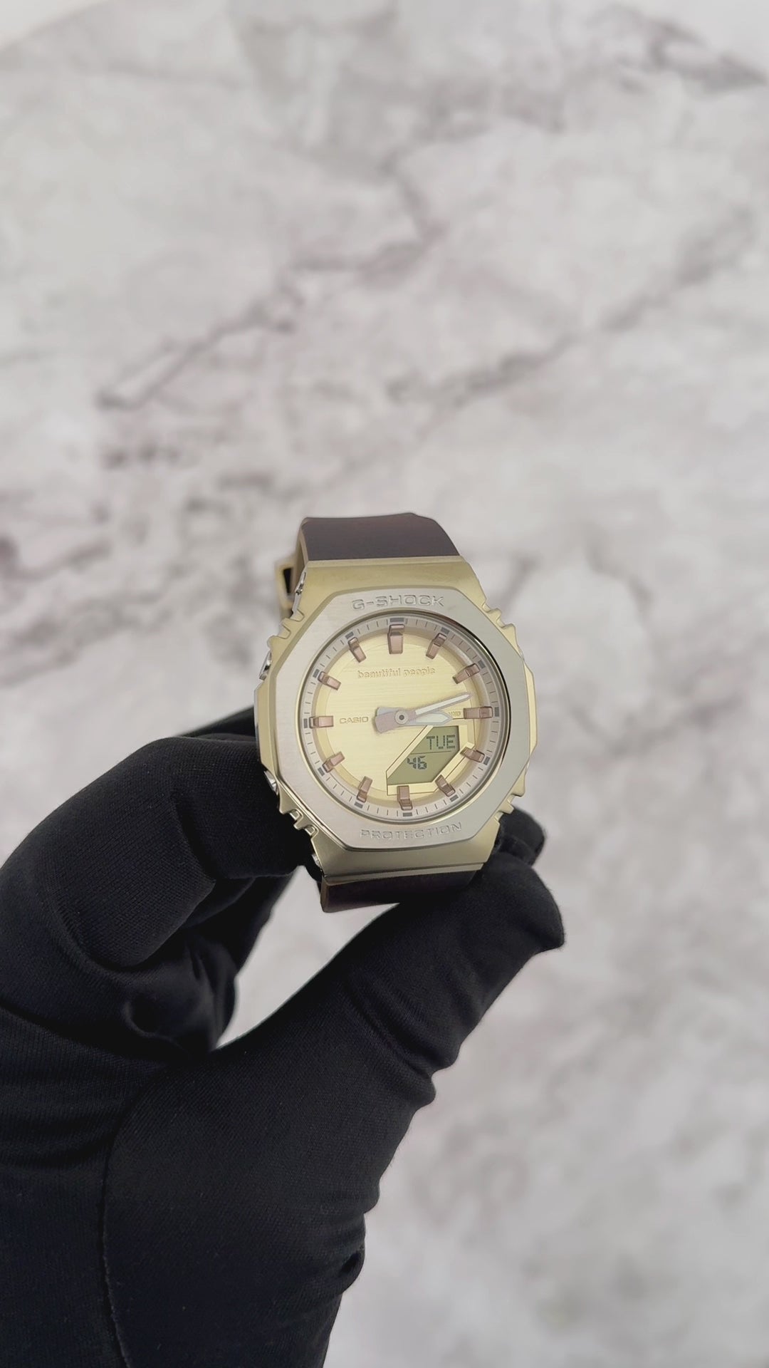 Casio G-SHOCK GMS2110BP-5A women’s analog-digital watch from the beautiful people collaboration, featuring an octagonal 2100 bezel, brown leather-textured bio-based resin band, gold ion-plated bezel, and refined vintage-inspired design.
