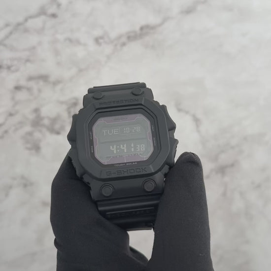 Casio G-SHOCK GX56BB-1 ‘King of G-SHOCK’ digital watch. Oversized 55.5 × 53.6 × 17.5 mm matte black resin case and band with mineral glass, mud- and shock-resistant structure, and Tough Solar power system. Features world time, stopwatch, countdown timer, 5 alarms, full auto-calendar, and EL blue-green backlight. 200-meter water resistant, 88 g weight, and battery life up to 27 months in power save mode.