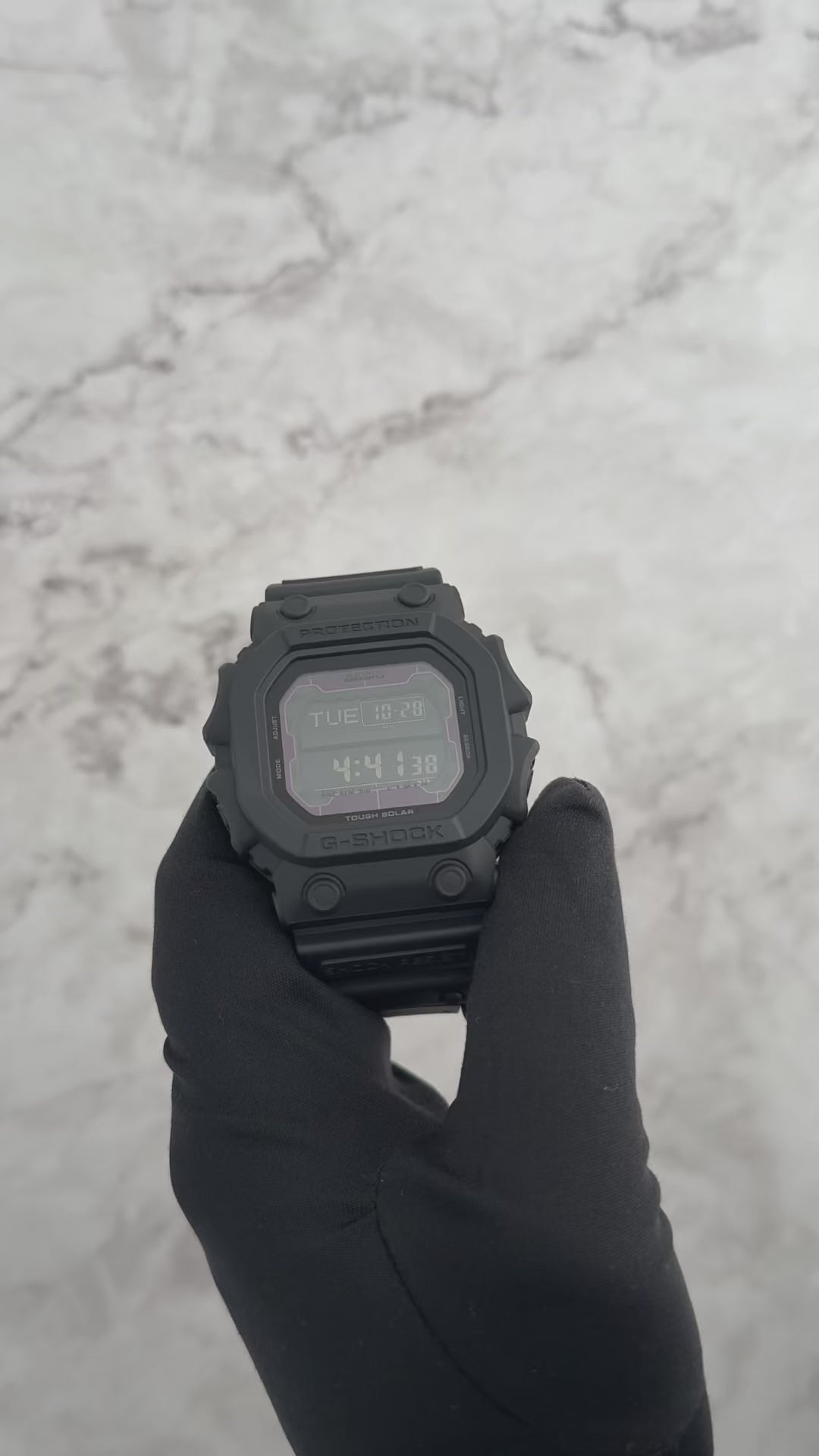 Casio G-SHOCK GX56BB-1 ‘King of G-SHOCK’ digital watch. Oversized 55.5 × 53.6 × 17.5 mm matte black resin case and band with mineral glass, mud- and shock-resistant structure, and Tough Solar power system. Features world time, stopwatch, countdown timer, 5 alarms, full auto-calendar, and EL blue-green backlight. 200-meter water resistant, 88 g weight, and battery life up to 27 months in power save mode.