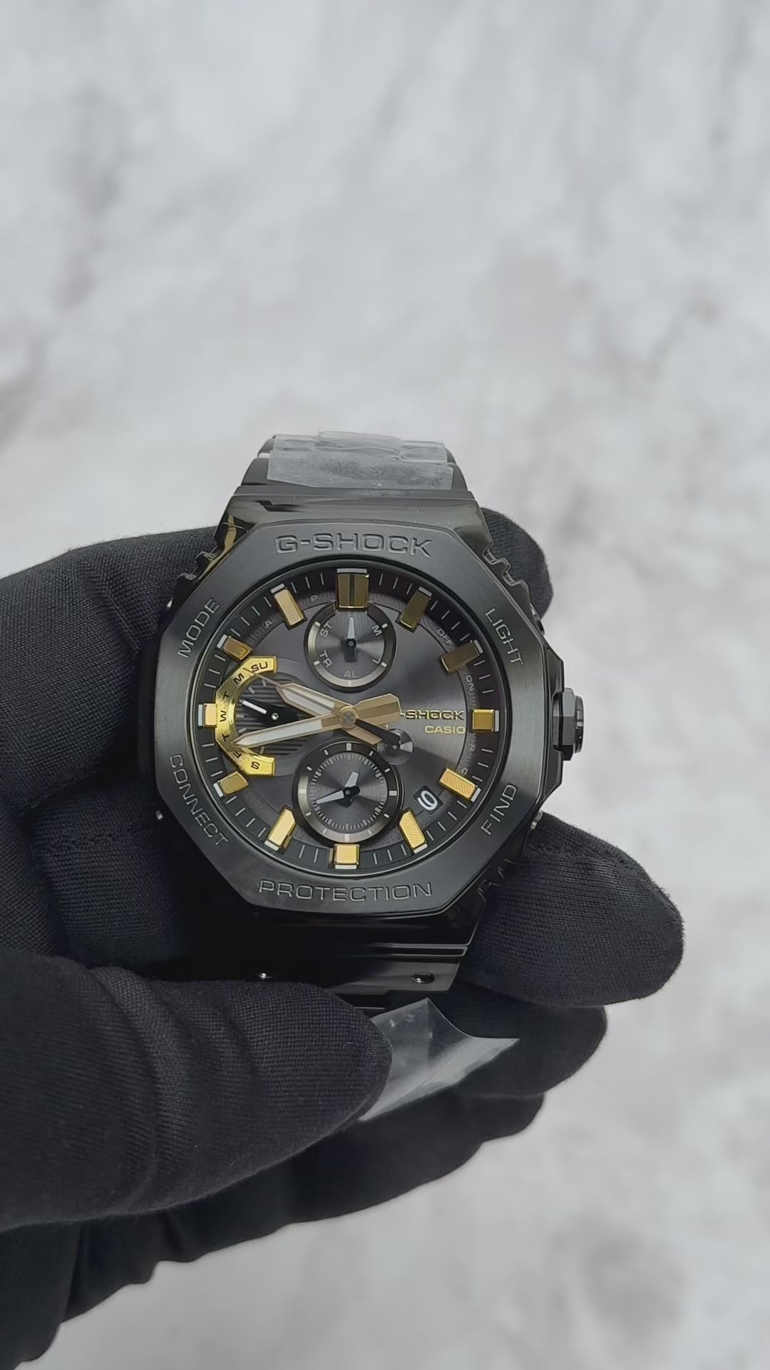 Casio G-SHOCK GMCB2100ZE1A 50th Anniversary full-metal black ion-plated watch with gold accent and binary code dial, limited edition released April 2025