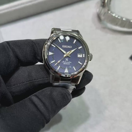 SEIKO Prospex SPB249 Alpinist – blue patterned dial with mountain-shaped markers, stainless steel case and bracelet, curved sapphire crystal, automatic movement, and 200m water resistance.