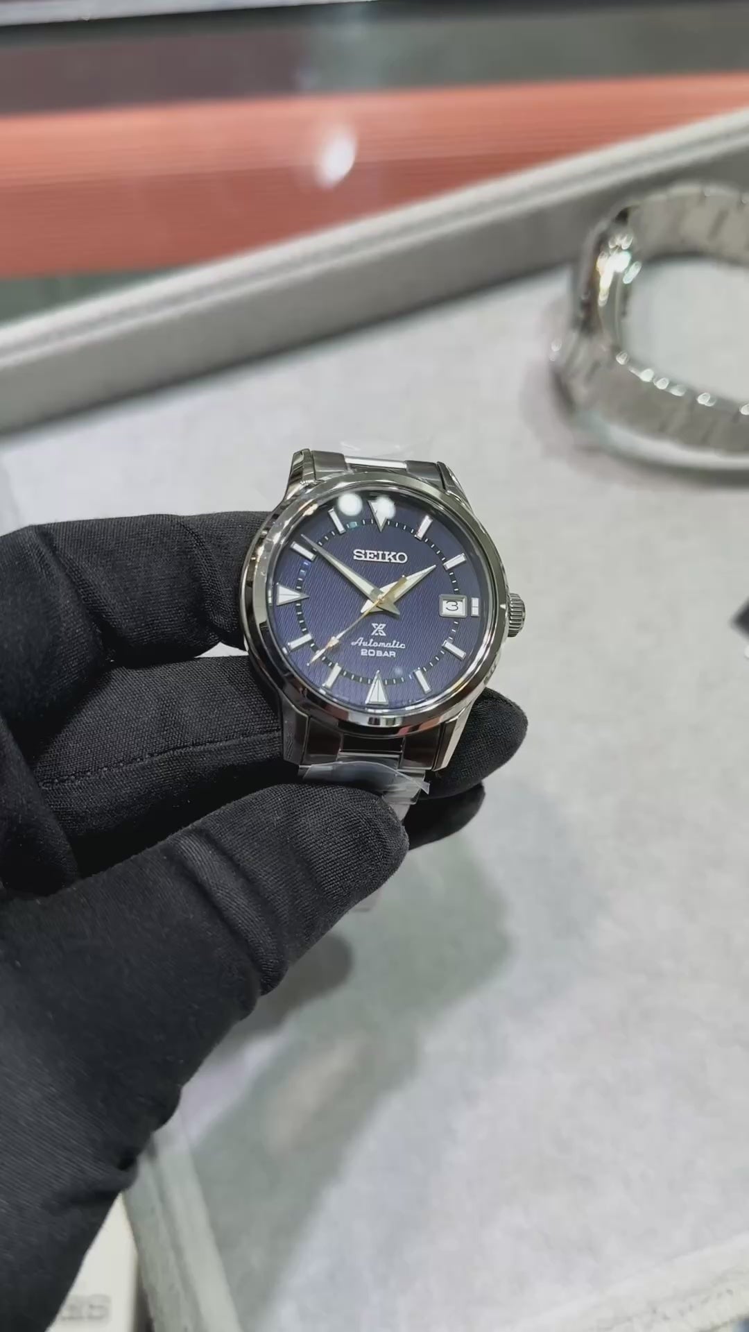 SEIKO Prospex SPB249 Alpinist – blue patterned dial with mountain-shaped markers, stainless steel case and bracelet, curved sapphire crystal, automatic movement, and 200m water resistance.