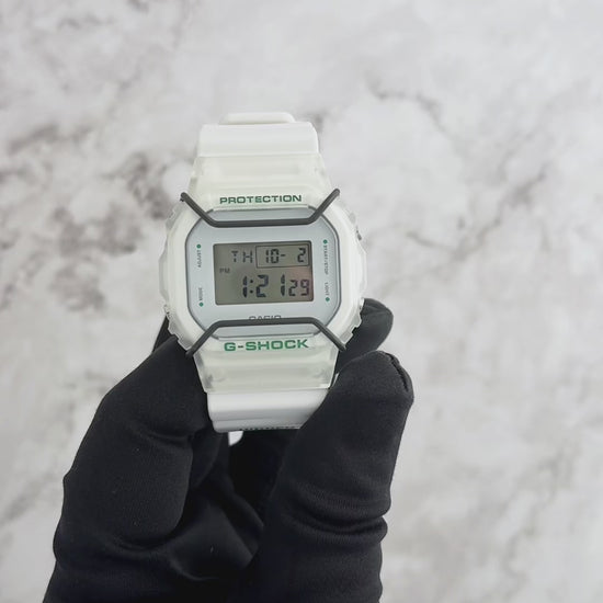 Casio G-SHOCK DW5600HDN257 – Limited Edition HIDDEN NY collaboration with white resin band, transparent green-accented bezel, black bull bars, engraved case back ‘IN THE BLINK OF AN EYE,’ HIDDEN NY logo backlight, special collector’s packaging, 200m water resistance.