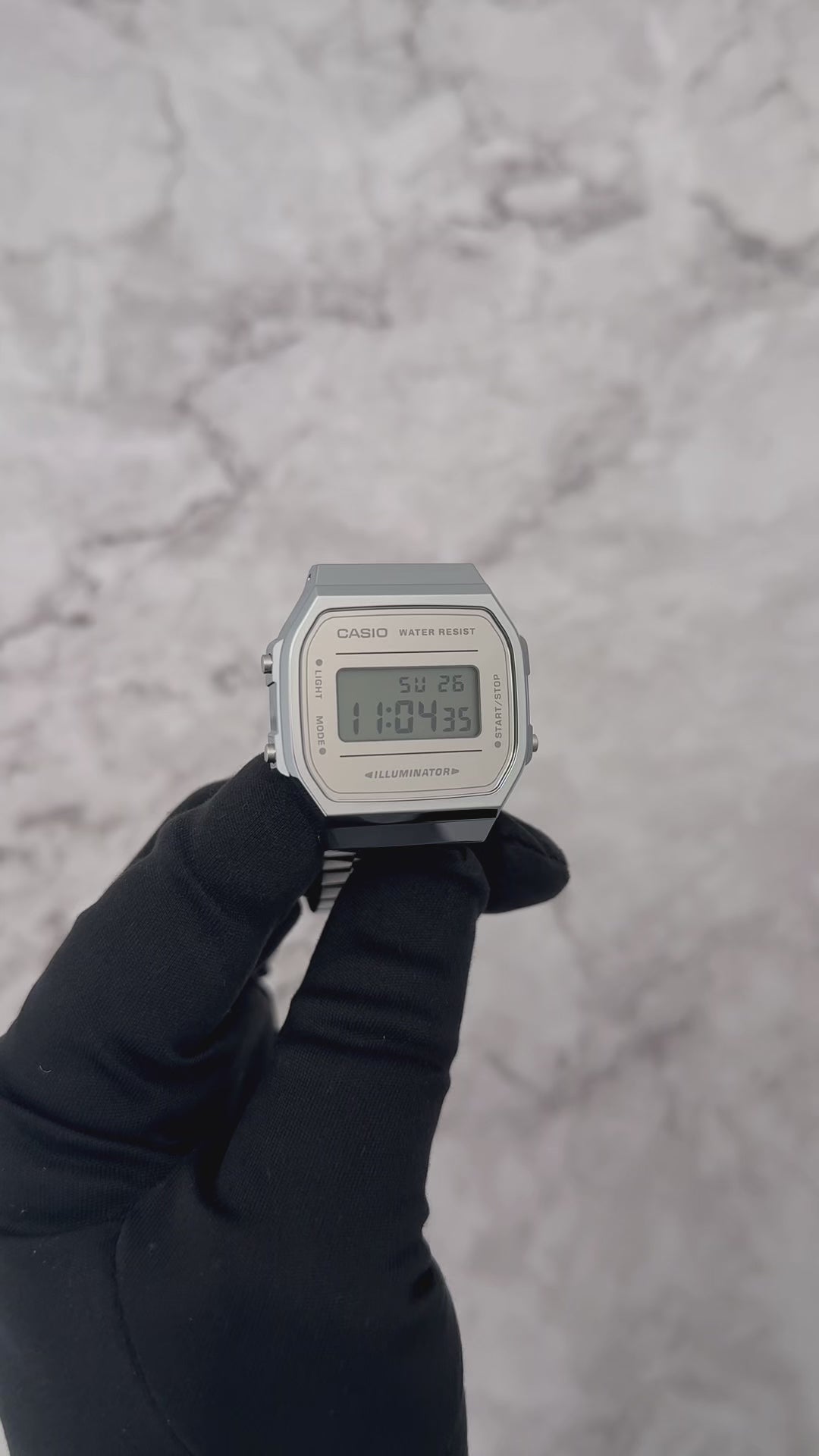 Casio Vintage A168WEM-7VT digital watch with a bright silver-tone stainless steel band, mirror-finish reflective dial, slim 9.6 mm profile, lightweight 49 g body, chrome-plated resin case, mineral glass, EL blue-green backlight, 1/100-second stopwatch, daily alarm, hourly time signal, auto-calendar, and long-lasting 7-year CR2016 battery.
