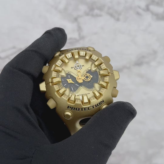 G-SHOCK GAV01A-9A gold-tone resin watch featuring sculpted futuristic case design, layered analog-digital open-work dial, full-screen LCD, magnetic Shock Release Hand structure, double LED Super Illuminator, and 200-meter water resistance.