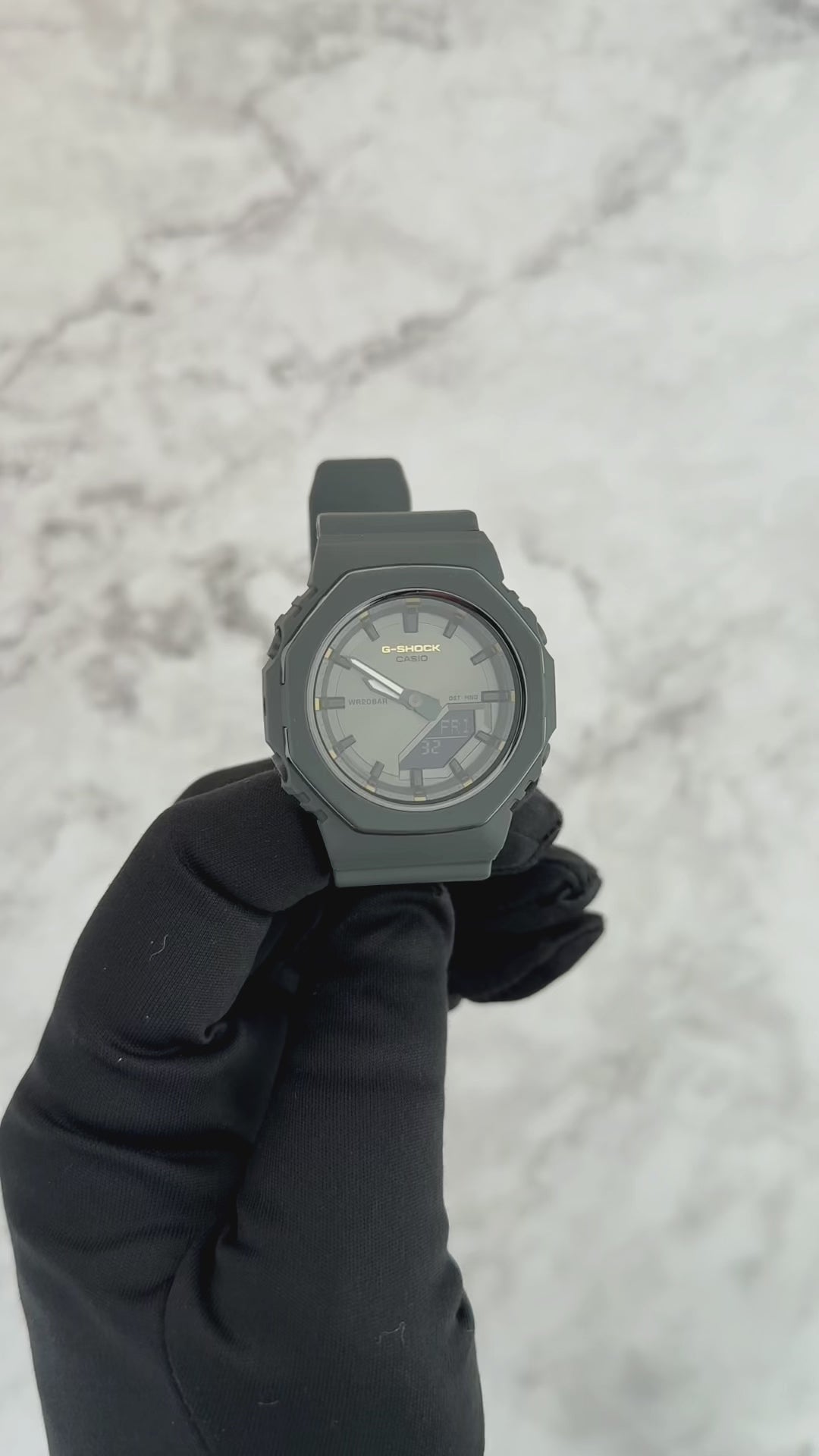 G-SHOCK GMAP2126W-8A International Women’s Day 2026 limited edition watch with metallic gray bezel, gold accents, monochrome dial, and bio-based resin band